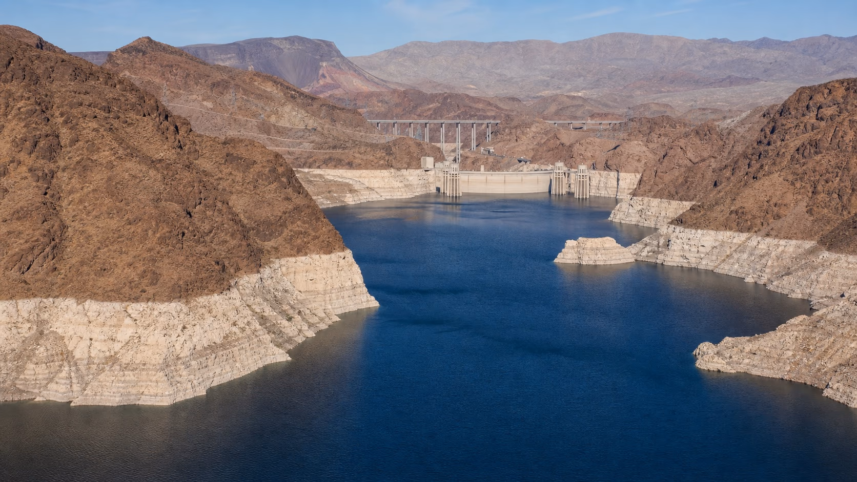 Original wide editorial image of Lake Mead, its pale mineral shoreline and Hoover Dam in the dry American Southwest